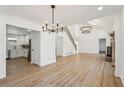 Open concept dining room with hardwood floors and two large chandeliers at 3939 Hamilton Mill Rd, Buford, GA 30519