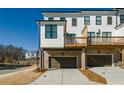 Rear view of townhome highlighting the deck and garage at 601 Millcroft Blvd, Buford, GA 30518