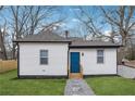 Side view of a renovated white house with a blue door at 1617 Church Ne St, Conyers, GA 30012