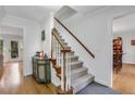 Bright entry with hardwood floors, a staircase with carpet runner, and classic white trim at 2225 Mountain Creek Dr, Stone Mountain, GA 30087