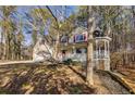 Two-story house with a wraparound porch and attached garage at 4684 Pine Dr, Loganville, GA 30052