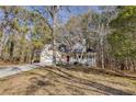 Two-story house with a wraparound porch and attached garage at 4684 Pine Dr, Loganville, GA 30052