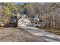 Two-story house with a long driveway and attached garage at 4684 Pine Dr, Loganville, GA 30052