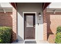 Dark brown front door with sidelights and red awning at 3301 Henderson Mill Rd # A2, Atlanta, GA 30341