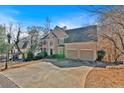 Brick home with a large driveway and mature trees at 820 Hillcrest Ln, Woodstock, GA 30189