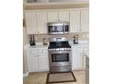 Kitchen features stainless steel appliances and white cabinets at 202 Marston Dr, Suwanee, GA 30024