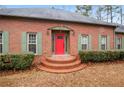 Red front door, brick steps, and green shutters at 3985 W Stubbs Rd, Atlanta, GA 30349