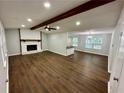 Spacious living room with hardwood floors, a fireplace, and high ceilings at 7035 Stone Wood Nw Dr, Kennesaw, GA 30152