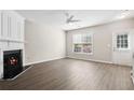 Bright living room with fireplace, wood floors, and ample natural light at 3742 Berkeley Xing, Duluth, GA 30096
