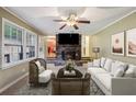 Living room features a brick fireplace and large windows at 19 Roving Hills Cir, Cartersville, GA 30121