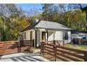 Quaint home featuring fenced front yard, mature trees, and inviting facade at 1018 Westmont Sw Rd, Atlanta, GA 30311