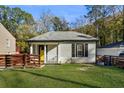 Charming single-story home with a well-manicured lawn, fenced yard, and welcoming porch at 1018 Westmont Sw Rd, Atlanta, GA 30311