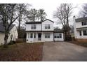Two-story house with white siding, driveway, and mature trees at 592 Waynes Ct, Atlanta, GA 30354