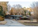 House exterior showcasing a large driveway and mature trees at 2341 Amberbrook Sw Dr, Conyers, GA 30094