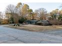 Exterior view of the house from a side street, showing yard and trees at 2341 Amberbrook Sw Dr, Conyers, GA 30094
