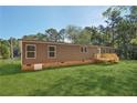 Brown single-wide manufactured home with wooden deck and steps at 248 Billy Bullock Rd, Dallas, GA 30157