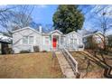 Newly renovated gray house with red door and white trim, steps leading to a porch at 1320 Hosea L Williams Ne Dr, Atlanta, GA 30317