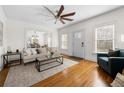 Bright living room with hardwood floors, comfy seating, and a view into the dining area at 1320 Hosea L Williams Ne Dr, Atlanta, GA 30317