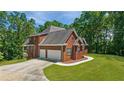 Spacious two-story brick home with a two-car garage and a large driveway at 6020 Cochran Mill Rd, Chattahoochee Hills, GA 30268