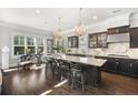 Spacious kitchen with a large island, granite countertops, stainless steel appliances, and hardwood floors at 1250 Atherton Park, Roswell, GA 30076