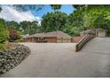 This property features an expansive driveway leading to a three-car garage and a separate parking area at 3781 Anneewakee Rd, Douglasville, GA 30135
