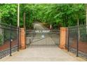 Private gated entrance displaying the property name with manicured landscaping to increase curb appeal at 3781 Anneewakee Rd, Douglasville, GA 30135