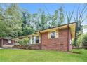 Brick house with a spacious lawn and mature trees at 3141 Bellgreen Way, Decatur, GA 30032