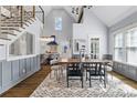 Bright dining room with cathedral ceiling, modern chandelier, and staircase at 1290 Pasadena Ne Ave, Atlanta, GA 30306