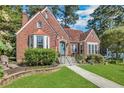 Beautiful brick home with a well-maintained lawn, brick retaining wall, and cozy front yard at 1290 Pasadena Ne Ave, Atlanta, GA 30306