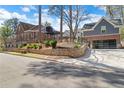 Beautiful home exterior with stone retaining wall and three car garage at 1290 Pasadena Ne Ave, Atlanta, GA 30306