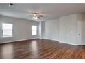 Hardwood floor living room with neutral walls and ceiling fan at 161 Parkview Place Dr, Mcdonough, GA 30253