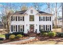 Two-story white house with black shutters and a manicured lawn at 275 Trowbridge Ln, Lawrenceville, GA 30043