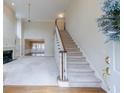 Two-story entryway with hardwood floors, a staircase, and views to the living room at 228 Spalding Gates Dr, Atlanta, GA 30328