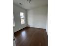 Bright bedroom with hardwood floors, neutral walls, and a double-hung window at 5043 Baywood Ln, Woodstock, GA 30188