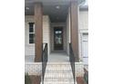 Front porch of home has brick columns, black railings, and a brick staircase at 5043 Baywood Ln, Woodstock, GA 30188