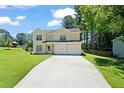 Two-story house with a two-car garage and landscaped lawn at 1215 Brook Meadow Ct, Lawrenceville, GA 30045