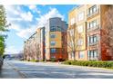 Modern apartment building with tree-lined street and city views in the background at 400 17Th Nw St # 2118, Atlanta, GA 30363