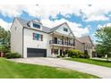 Two-story home with white brick and a large driveway, situated in a neighborhood at 5060 Lloyd Ln, Cumming, GA 30040