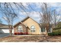 Well-maintained single-story house featuring stone details and beautiful landscaping at 2191 Rockbridge Sw Rd # 202, Stone Mountain, GA 30087