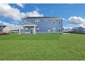 Large backyard with grassy lawn and covered patio at 328 Meuse Ln, Locust Grove, GA 30248