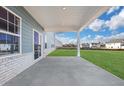 Covered patio with concrete flooring and access to backyard at 328 Meuse Ln, Locust Grove, GA 30248