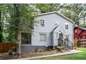 Two-story house with gray siding, a landscaped yard, and walkway at 1574 Mayflower St, Atlanta, GA 30311