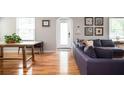 Living room with hardwood floors, sectional sofa, and wooden coffee table at 1574 Mayflower St, Atlanta, GA 30311