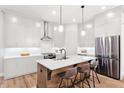 Stylish kitchen with white cabinetry, stainless steel appliances, and a central island with seating at 418 Townly, Alpharetta, GA 30009