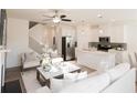 Open concept living room with contemporary furnishings, sleek staircase, and a ceiling fan at 1621 Aiden Way # 57, Conyers, GA 30013