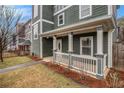 Inviting porch featuring white pillars and trim, complemented by landscaped flower beds at 692 Rose Palm Ln, Atlanta, GA 30315