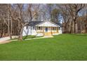 Stylish home with a welcoming porch and vibrant green lawn, perfect for outdoor enjoyment at 1506 Country Ct, Auburn, GA 30011