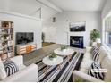 Virtually staged living room with fireplace and large windows at 2845 Robinson Wood Dr, Riverdale, GA 30296
