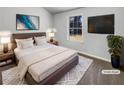 Virtually staged main bedroom with large window and TV at 2845 Robinson Wood Dr, Riverdale, GA 30296