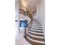 Elegant curved staircase with dark wood steps, wrought iron railing, and decorative chandelier at 1060 Morley Se Ave, Atlanta, GA 30312